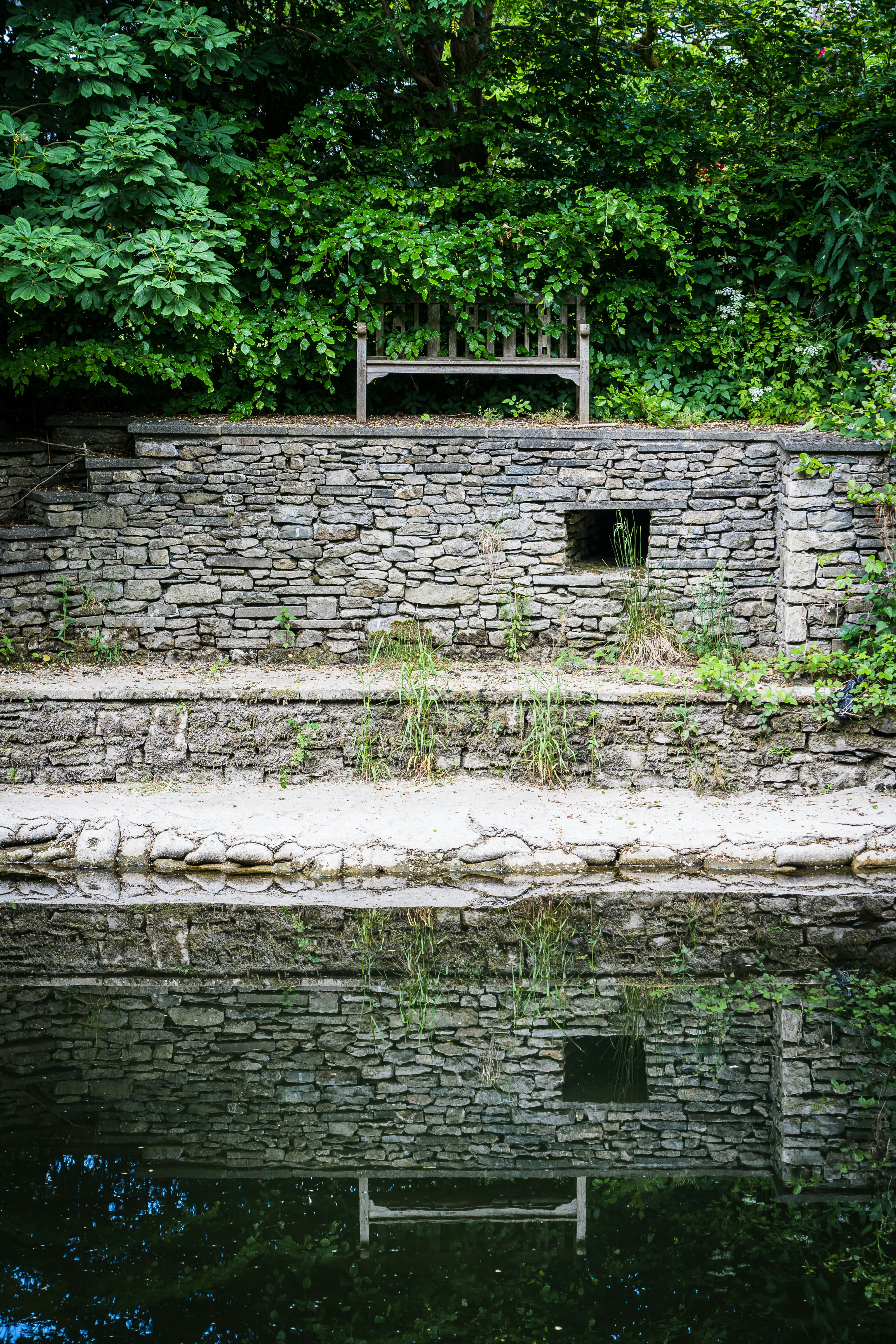 brown brick house near river during daytime